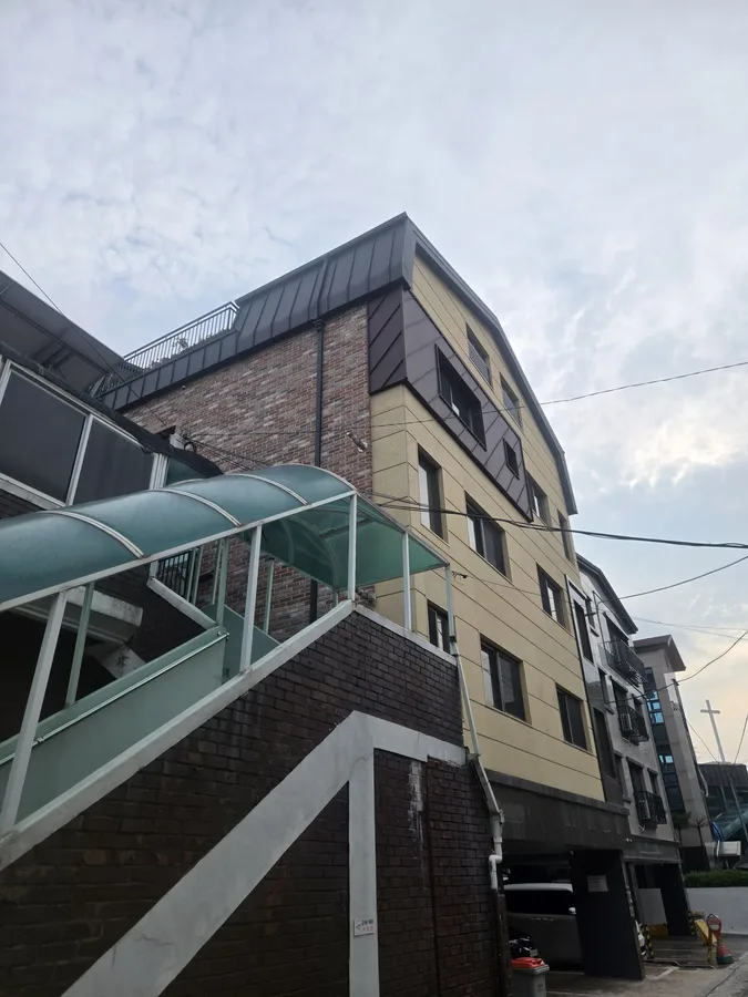 녹지를 배경으로 한 모던 건물 외관 전경 사진
